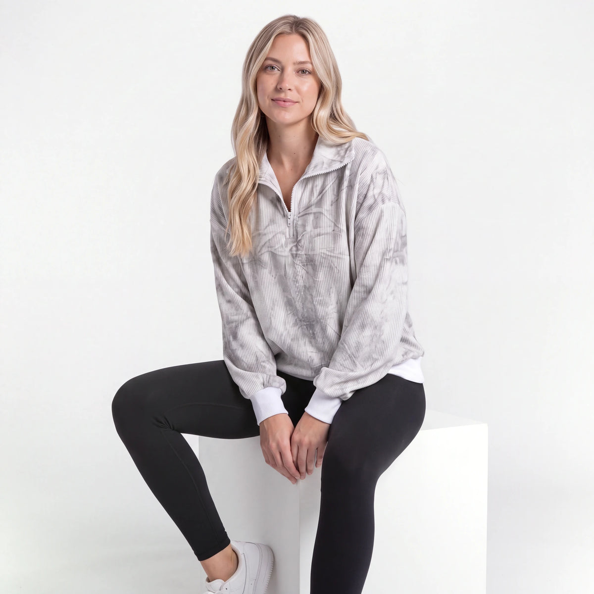 Woman wearing the Gray Tie-Dye quarter zip, seated