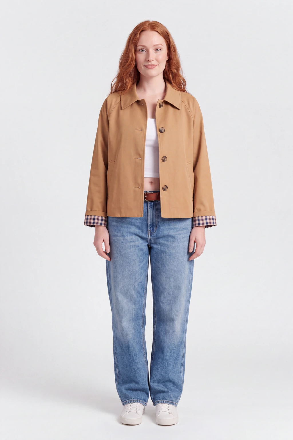 Woman wearing the cropped trench coat with plaid lining